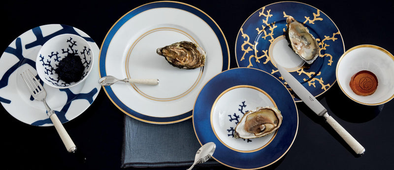 Styled Cristobal Marine luxury porcelain dinnerware by Raynaud with coral design in blue, gold, and white