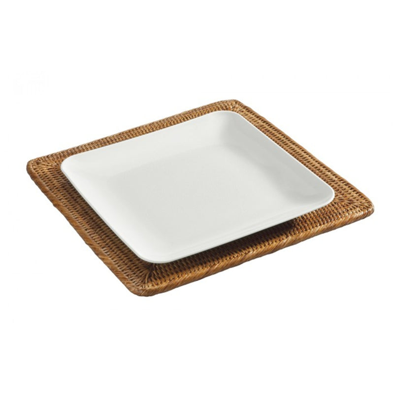 Kiko square rattan placemat in honey brown hand-woven design with plate on top.