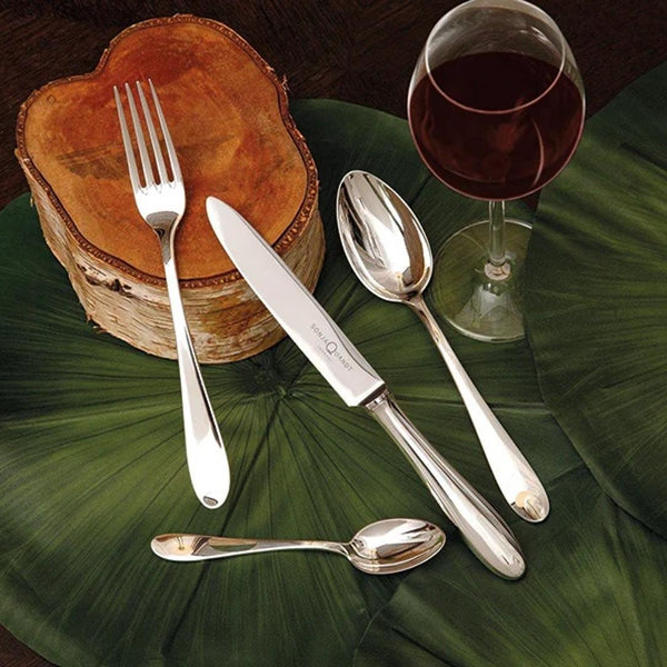 Silver-plated Avantgarde coffee spoon by Sonja Quandt sttyled next to wine glass.