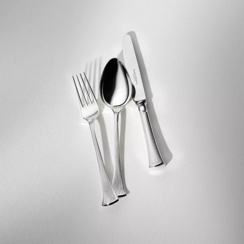 Silver-plated Avenue table knife next to matching fork and spoon.