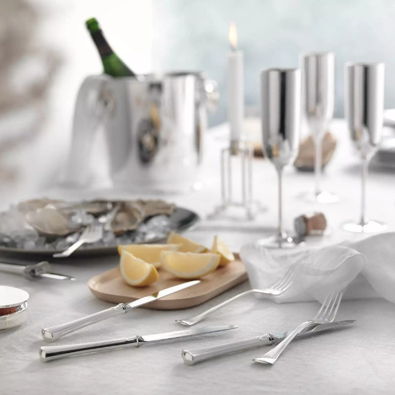 Silver-plated Avenue menu knife with polished blade and sculpted ridges on elegant table.