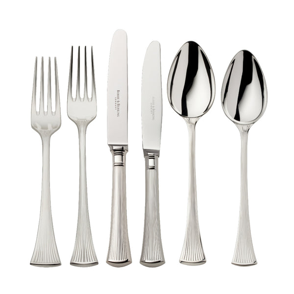 Silver-plated 36-piece Avenue cutlery set with sculpted ridges reflecting light on elegant table.