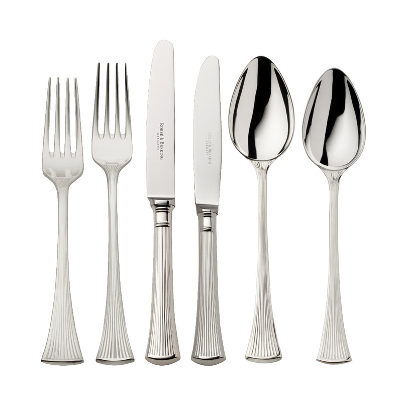 Silver-plated 36-piece Avenue cutlery set with sculpted ridges reflecting light on elegant table.