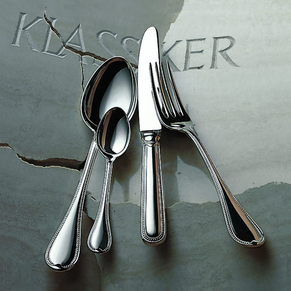 Robbe & Berking Französisch-Perl silver-plated menu spoon next to fork, knife and coffee spooon.
