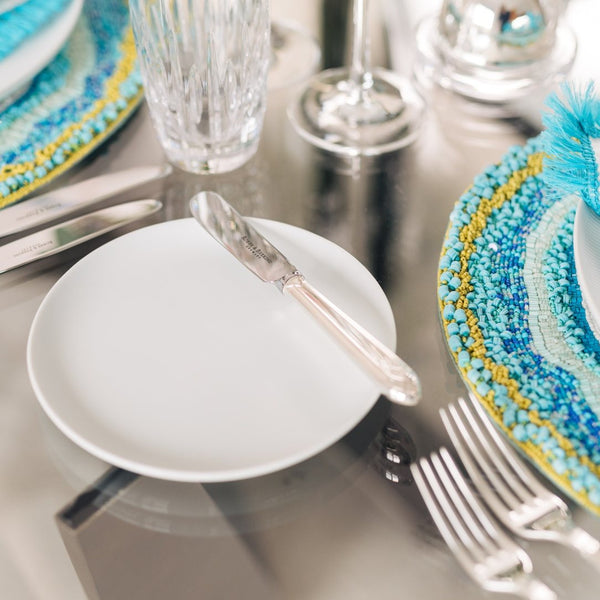 Navette silver-plated butter spreader by Robbe & Berking on turquoise tablescape.