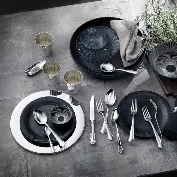 Alt Chippendale silver plated dessert fork next to other pieces from the collection on luxury tablescape.