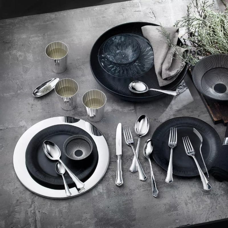 Alt Chippendale silver plated dessert fork next to other pieces from the collection on luxury tablescape.