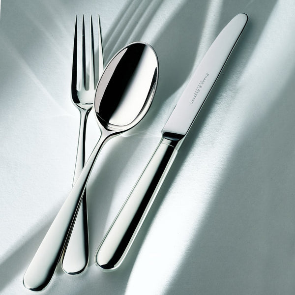 Dante silver-plated menu knife with balanced lines and elongated blade next to fork and spoon