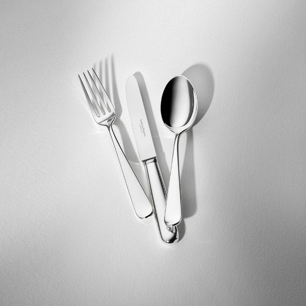 Dante silver-plated dessert spoon displayed next to spoon and knife