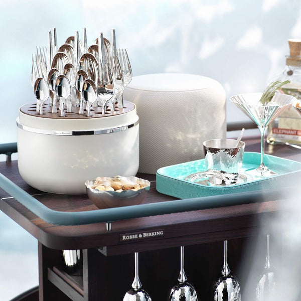 Dante silver-plated cutlery in creme presentation box styled on bar table.
