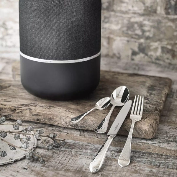 Martelé silver-plated cutlery by Robbe & Berking next to black storage box.