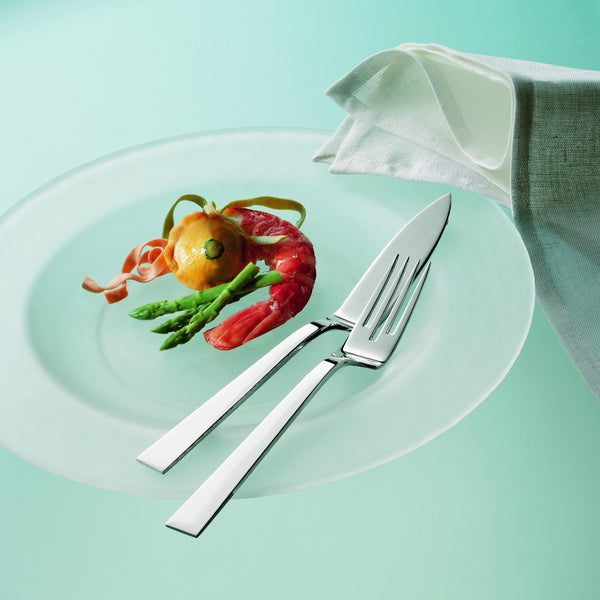 Riva fish knife and fish fork with tapered blade and silver-plated squared handle on plate.