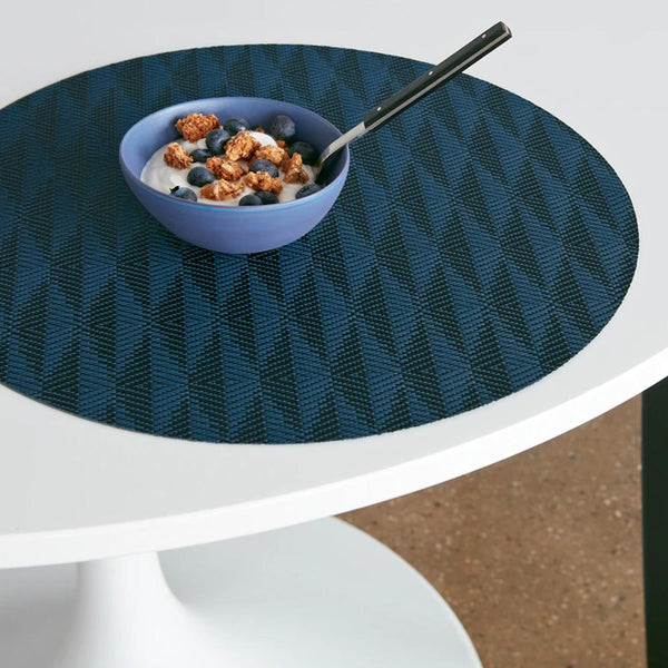 Chilewich Arrow placemat in sapphire blue with geometric weave on breakfast table.