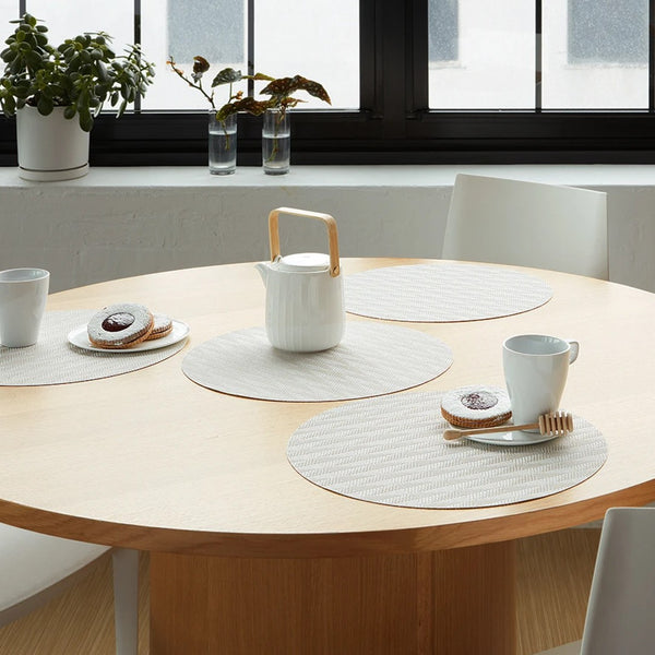 Ivory rectangular Arrow placemat with modern woven design by Chilewich on modern minimalist table.