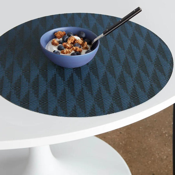 Chilewich sapphire blue Arrow placemat in woven vinyl design on breakfast table.