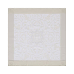 Venezia cotton napkin with subtle ivory floral pattern and classic silhouette, on white background
