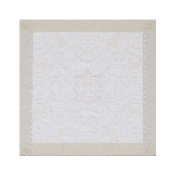 Venezia cotton napkin with subtle ivory floral pattern and classic silhouette, on white background
