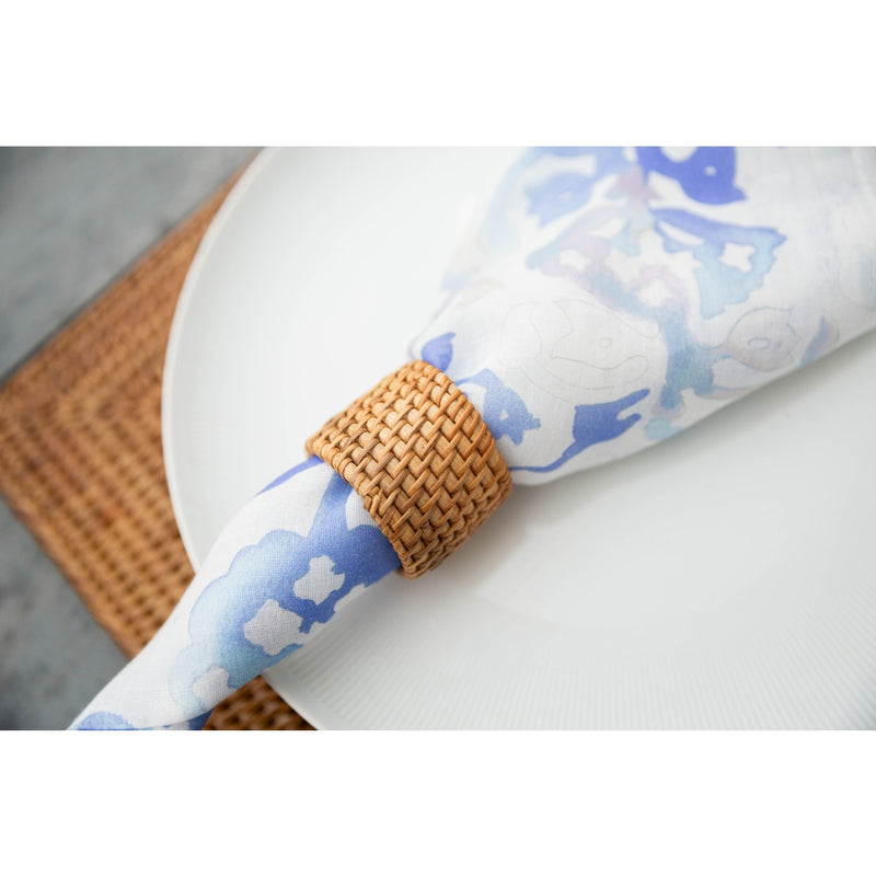 Coastal table décor in blue and white with brown handwoven rattan napkin ring
