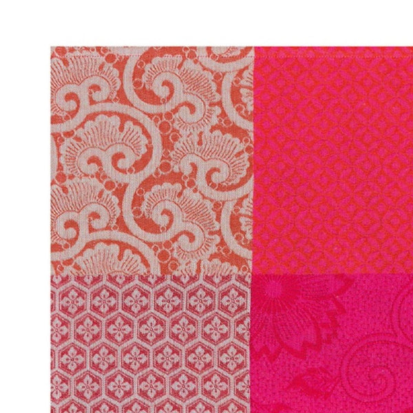 Cherry red cotton placemat with Japanese floral design close-up.
