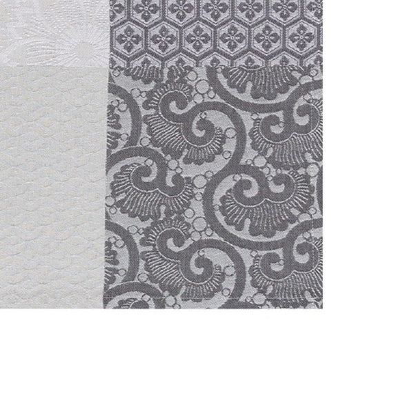 Mist grey cotton placemat with Japanese floral motifs close-up.