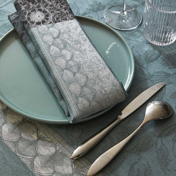 Grey linen placemat with baroque motifs by Le Jaquard Francais close-up on texture.