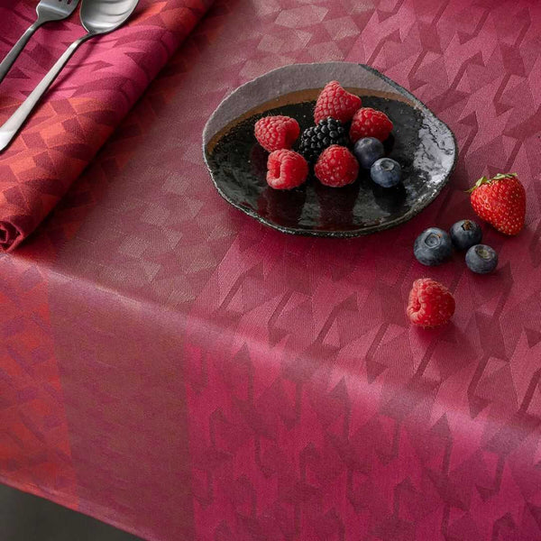 Red coated cotton placemat with retro inspired graphics close-up.