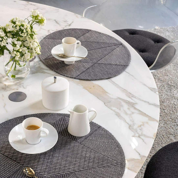 Grey cotton placemat with jacquard geometric weave on breakfast table.