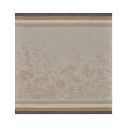 Beige and brown linen napkin with floral pattern by Le Jacquard Français unwraped on white background