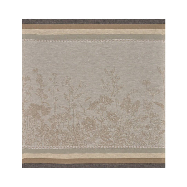 Beige and brown linen napkin with floral pattern by Le Jacquard Français unwraped on white background