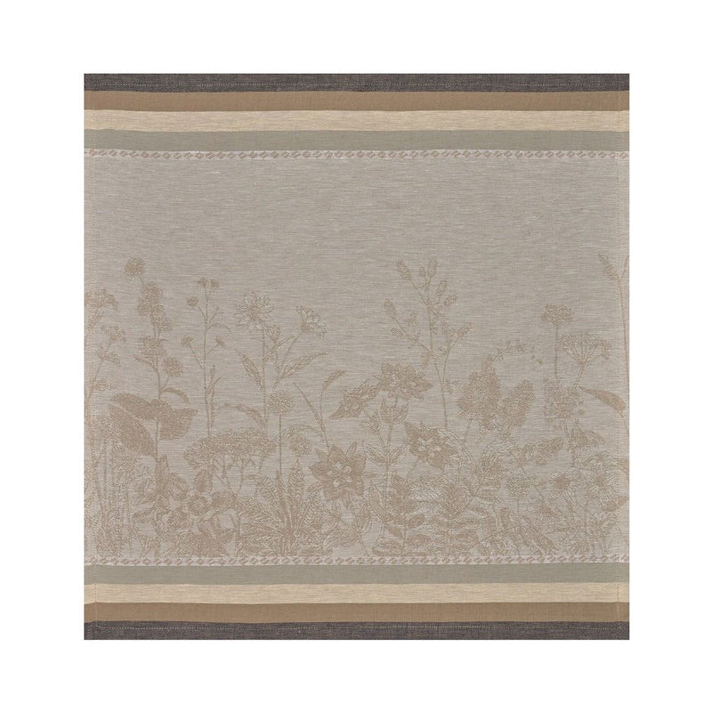 Beige and brown linen napkin with floral pattern by Le Jacquard Français unwraped on white background