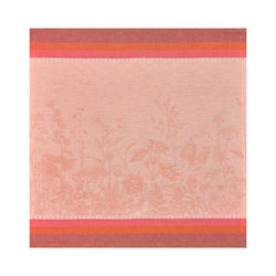 Coral floral linen napkin by Le Jacquard Français unwrapped on white background.