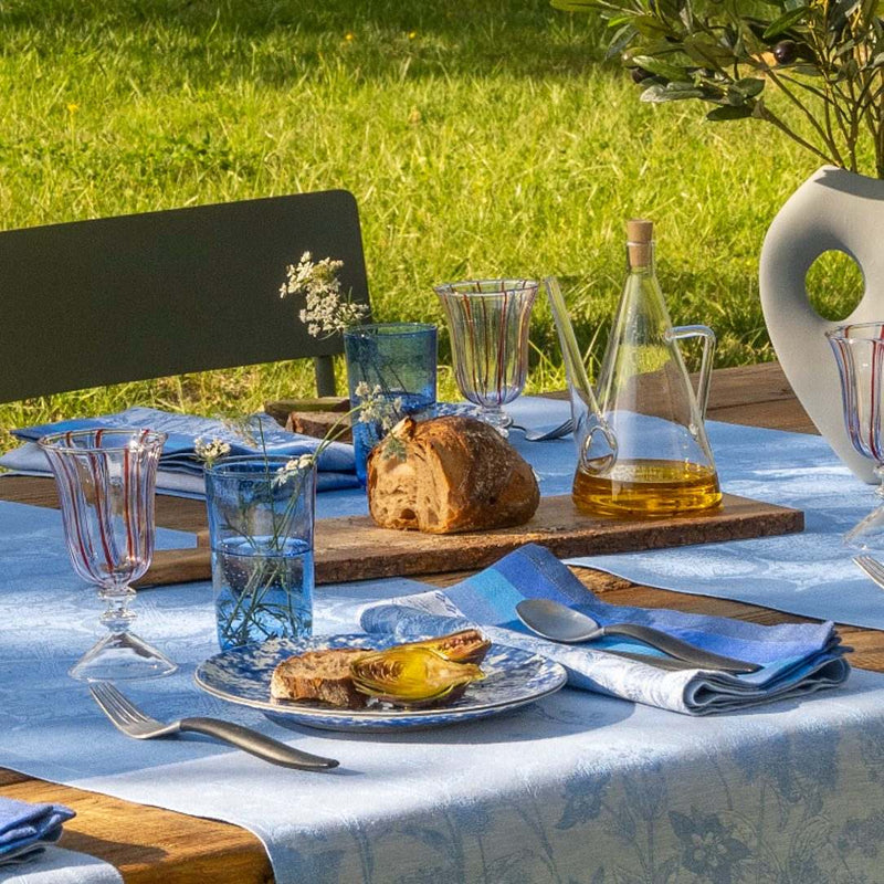 Instant Bucolique napkin styled on a  summer table with tablecloth from the same collection, sold by Amiramour
