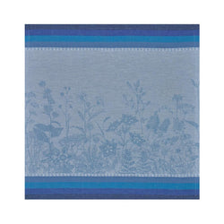 Blue  linen napkin with floral pattern by Le Jacquard Français unwraped on white background.