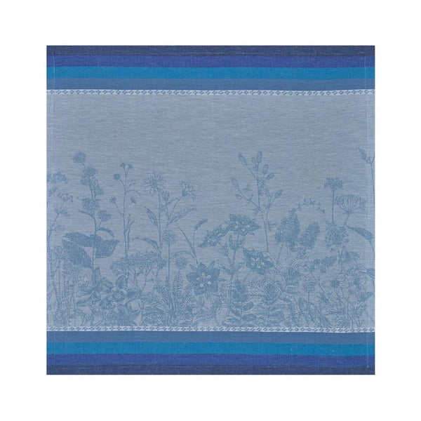 Blue  linen napkin with floral pattern by Le Jacquard Français unwraped on white background.