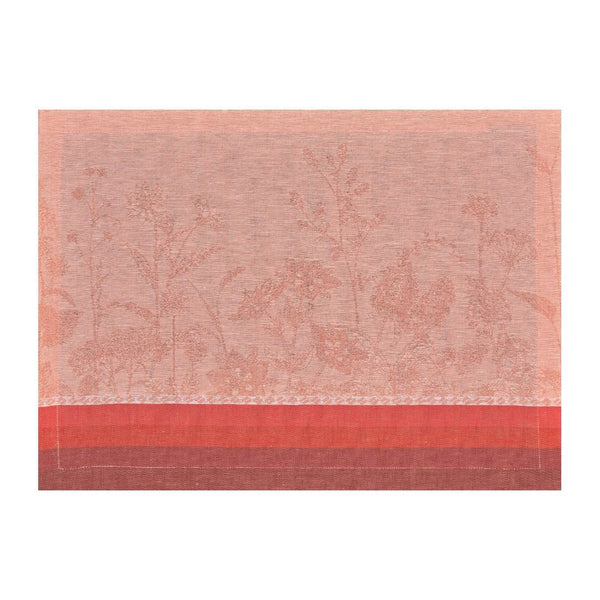 Pink red linen placemat with floral motifs in soft tones by Le Jaquard Francais.
