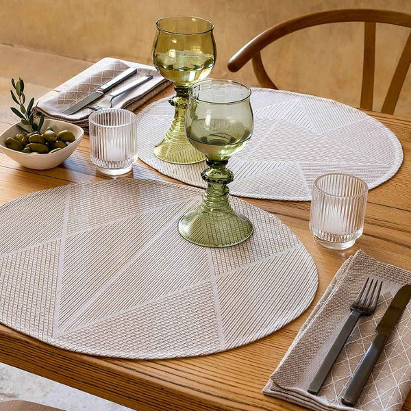 Beige cotton napkin with geometric jacquard weave by Le Jacquard Français styled on casual table setting.