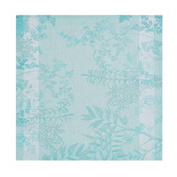 Blue Jardin d’Eden cotton napkin with delicate floral pattern unwraped on white background, sold at Amiramour.
