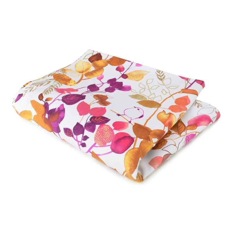 Folded fabric with colorful leaf pattern on a white background