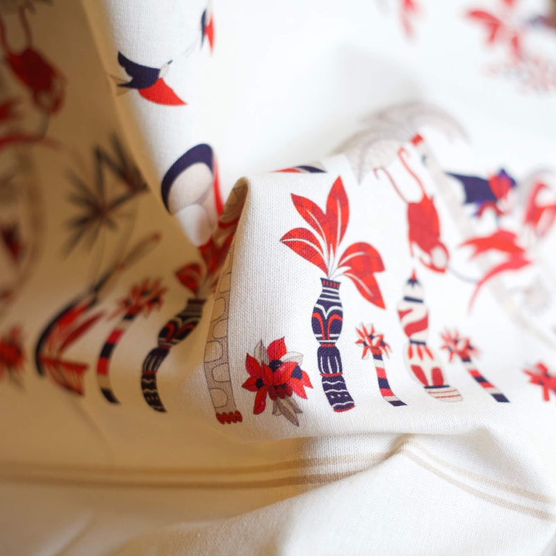 a white fabric with red and blue designs