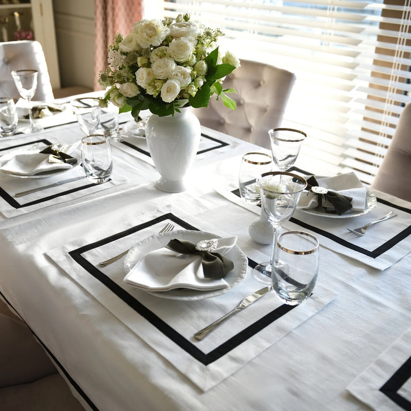 Elegant white tablecloth with black stripe border made from 100% Italian cotton.
