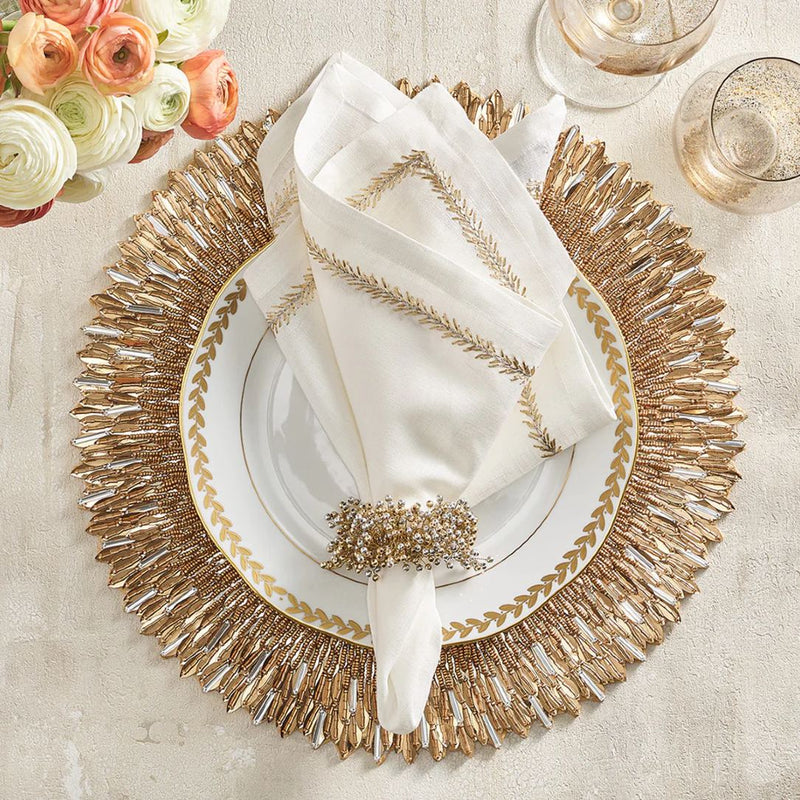 Top view of Jardin linen napkin styled with gold napkin ring and placemat by Amiramour