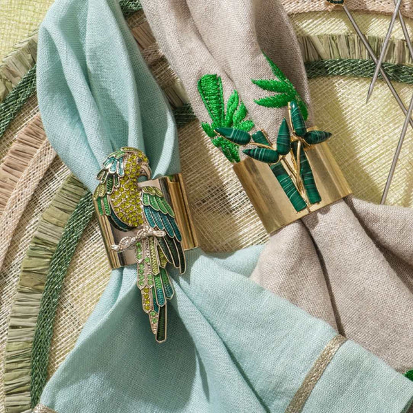 Parrot napkin rings by Joanna Buchanan styled on rattan placemat.