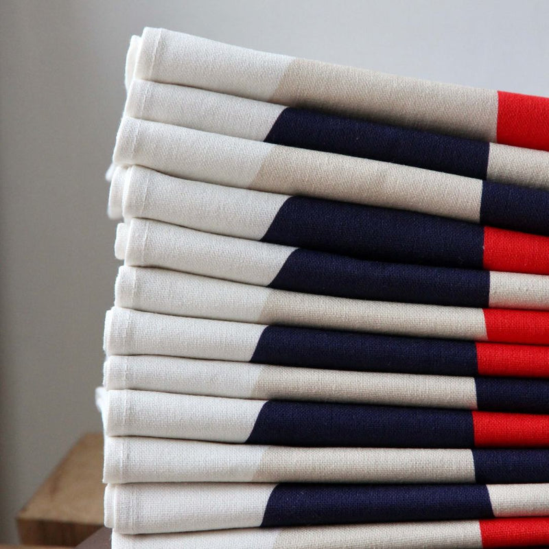 Alto Duo Bubble Ecru napkins, stacked to show multicolor bubble patterns and ecru base.