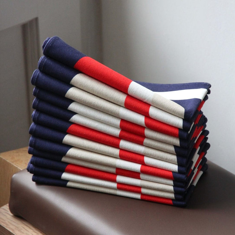 Napkin with vibrant red, white, and ivory 70s-inspired bubble motifs stacked on top of each other.