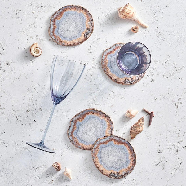 Strata Drink Coasters in beige, taupe, and gray with layered design with blue glassware.