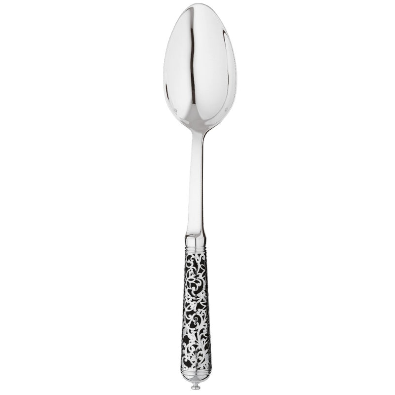 Sterling silver serving spoon with wide bowl and black handle decorated with silver arabesque motif.