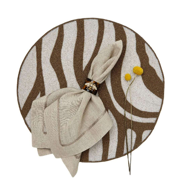 Zebra beaded placemats with brown stripes by Joanna Buchanan styled with bee motif napkin ring.
