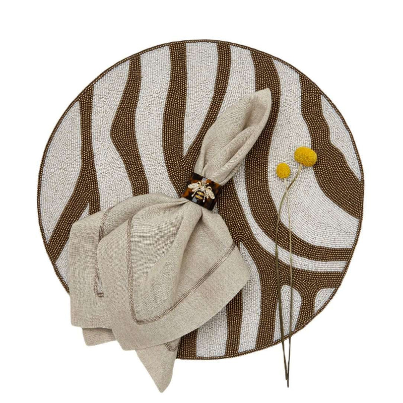 Zebra beaded placemats with brown stripes by Joanna Buchanan styled with bee motif napkin ring.