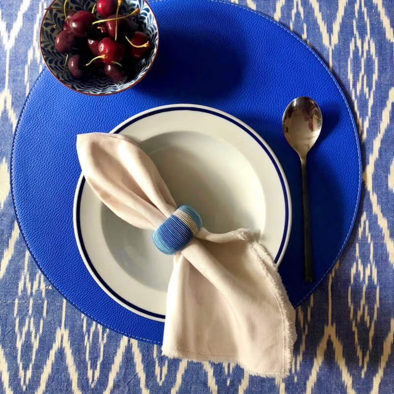 Reversible placemat in blue and white faux leather styled blue side.