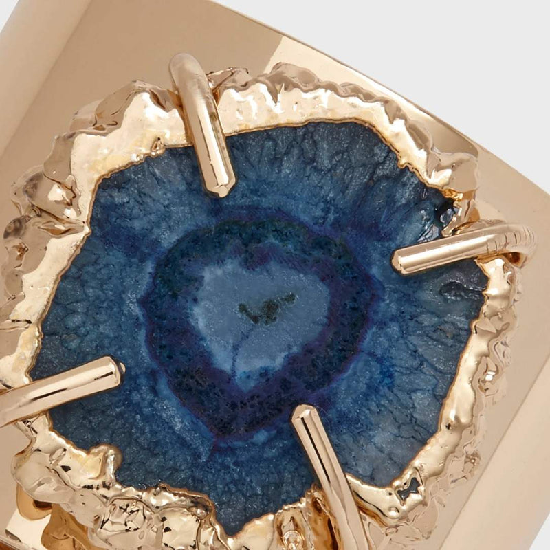 Close-up of indigo quartz napkin ring with gold edges by Joanna Buchanan